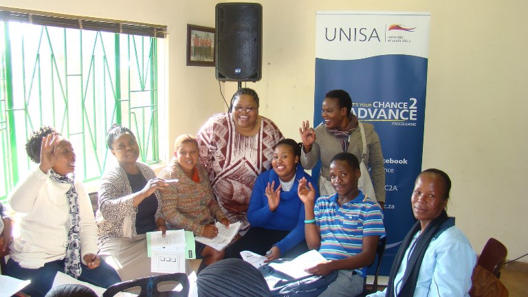 Facilitator Mrs Bongi Zengele with participants engaging in group work
